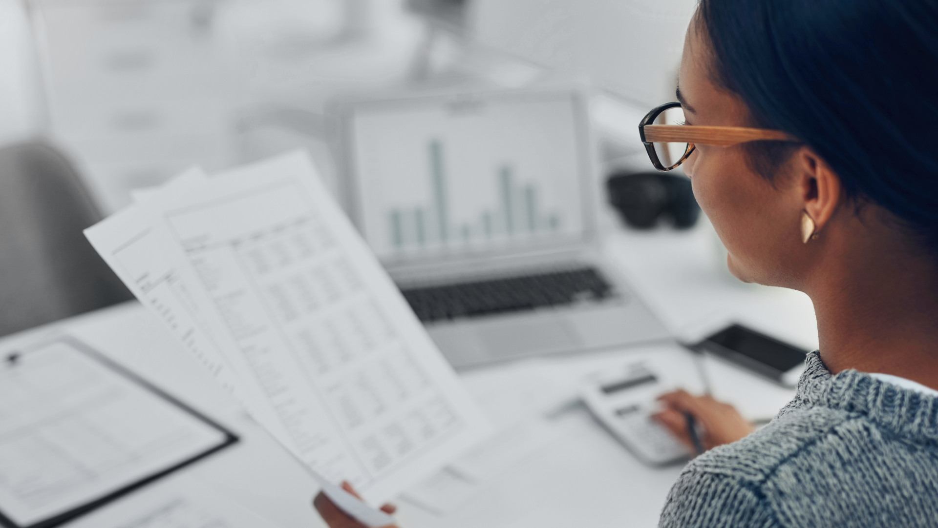 Persoon die financiële documenten analyseert.